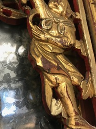 A rare Chinese gilt wood and reverse glass painted mirror, 2nd half 18th C.