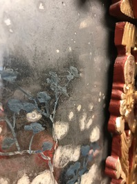 A rare Chinese gilt wood and reverse glass painted mirror, 2nd half 18th C.