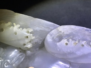 A Chinese white jade group with boys on a raft on carved wooden base, Qing