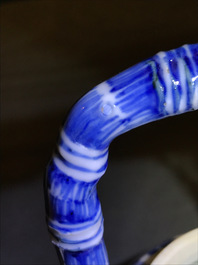 A Chinese blue and white gate-handled teapot and cover, Kangxi