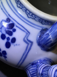 A Chinese blue and white gate-handled teapot and cover, Kangxi