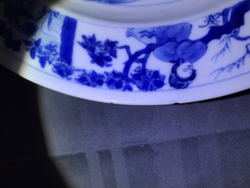 A Chinese blue and white plate with figures in a pagoda, Kangxi