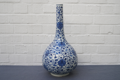A Chinese blue and white 'lotus scroll' bottle vase, 18/19th C.