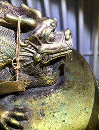 A Chinese gilt bronze bell in zitan suspension frame, Qianlong mark, 18/19th C.