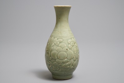 A Chinese relief-decorated celadon 'peony' vase, 18/19th C.