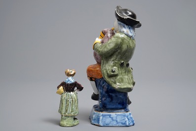 Two polychrome Dutch Delft models of a bagpipe player and a lady, 19th C.