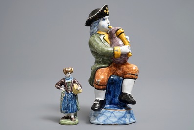 Two polychrome Dutch Delft models of a bagpipe player and a lady, 19th C.