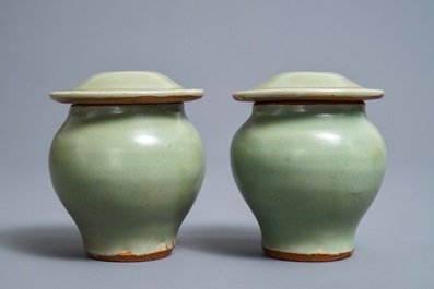A pair of Chinese Longquan celadon vases and covers, Ming
