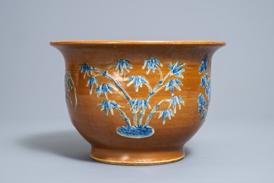 A Chinese blue and white on brown ground cachepot, 19th C.