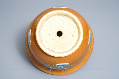 A Chinese blue and white on brown ground cachepot, 19th C.
