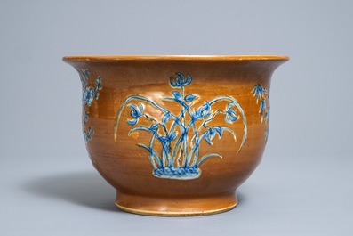 A Chinese blue and white on brown ground cachepot, 19th C.