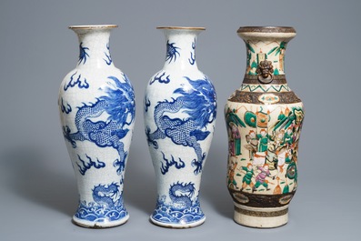 A pair of Chinese Nanking 'dragon' vases and a 'warrior' vase, 19th C.