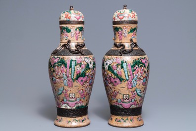 A pair of Chinese Nanking famille rose vases and covers, 19th C.