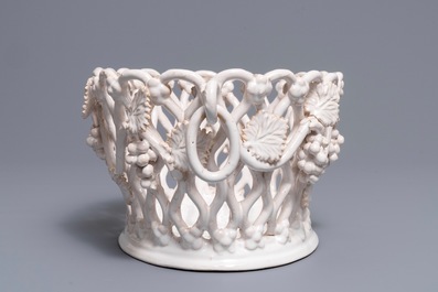 A white-glazed reticulated 'grape vines' basket, France or Italy, 19th C.