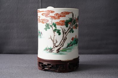 A Chinese famille verte brush pot on wooden stand, Kangxi