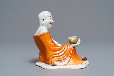 A Chinese iron red decorated figure of a Luohan, Qianlong