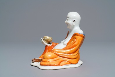 A Chinese iron red decorated figure of a Luohan, Qianlong