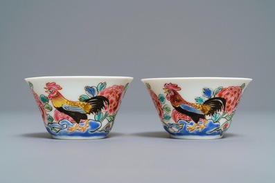 A pair of Chinese famille rose 'roosters' cups and saucers, Yongzheng/Qianlong