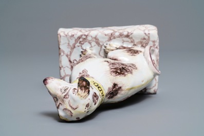 A manganese and yellow Brussels faience model of a dog, 18th C.