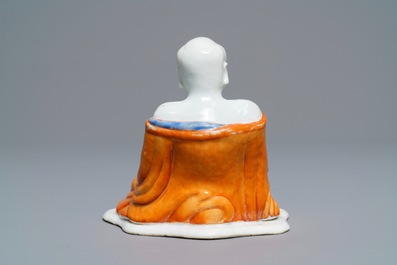 A Chinese iron red decorated figure of a Luohan, Qianlong
