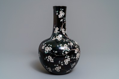 A Chinese famille noire tianqiu ping vase with birds among blossoms, 19th C.