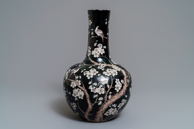 A Chinese famille noire tianqiu ping vase with birds among blossoms, 19th C.