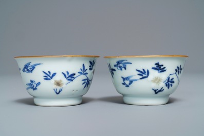 A pair of Chinese blue, white and underglaze red cups and saucers, Kangxi