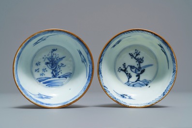 A pair of Chinese blue, white and underglaze red cups and saucers, Kangxi