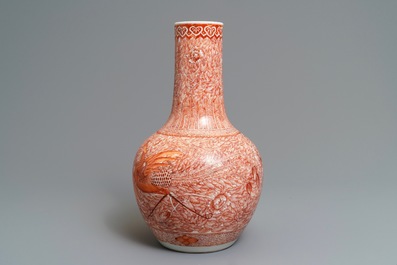 A Chinese iron red 'dragon and phoenix' bottle vase, 19th C.