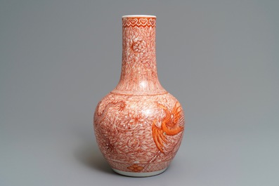 A Chinese iron red 'dragon and phoenix' bottle vase, 19th C.