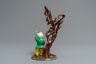 A Chinese verte biscuit group with a boy near a blossoming tree, Kangxi