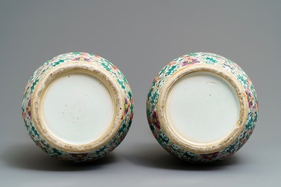 A pair of Chinese famille rose lady-handle vases, 19th C.