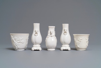 Three Chinese blanc de Chine vases and two cups with applied designs, Kangxi and later