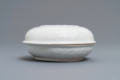A Chinese Dehua blanc de Chine relief-decorated box and cover, incised mark, Kangxi