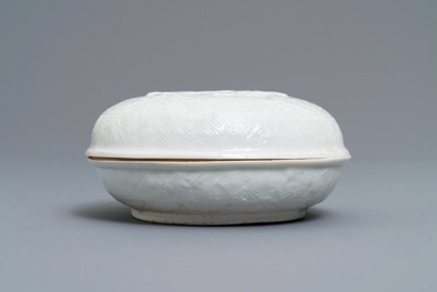 A Chinese Dehua blanc de Chine relief-decorated box and cover, incised mark, Kangxi