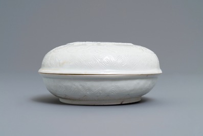 A Chinese Dehua blanc de Chine relief-decorated box and cover, incised mark, Kangxi