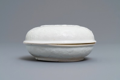 A Chinese Dehua blanc de Chine relief-decorated box and cover, incised mark, Kangxi