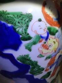 A Chinese wucai baluster vase and cover with playing boys, Transitional period