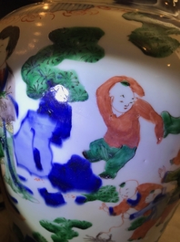 A Chinese wucai baluster vase and cover with playing boys, Transitional period