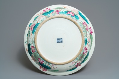 A massive Chinese famille rose 'ducks in a lotus pond' charger, Qianlong mark, 19th C.