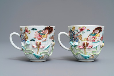 A pair of Chinese famille rose 'rooster' cups and saucers with applied floral designs, Yongzheng