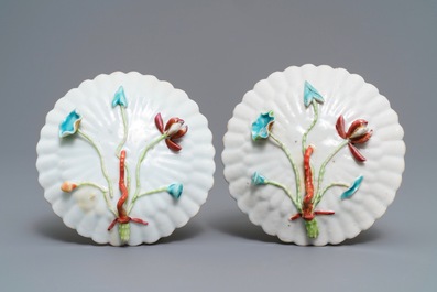 A pair of Chinese famille rose 'rooster' cups and saucers with applied floral designs, Yongzheng