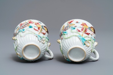 A pair of Chinese famille rose 'rooster' cups and saucers with applied floral designs, Yongzheng