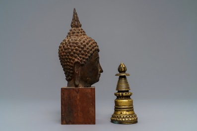 A Tibetan gilt bronze stupa and a lacquered bronze Buddha head, Laos, 16/17th C.