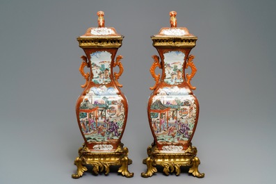 A pair of large Chinese ormolu-mounted famille rose 'mandarin' vases and covers, Qianlong