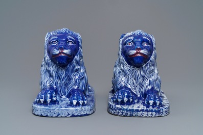 A pair of blue-ground models of recumbent lions, Saint-Omer, France, late 18th C.