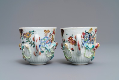A pair of Chinese famille rose 'rooster' cups and saucers with applied floral designs, Yongzheng