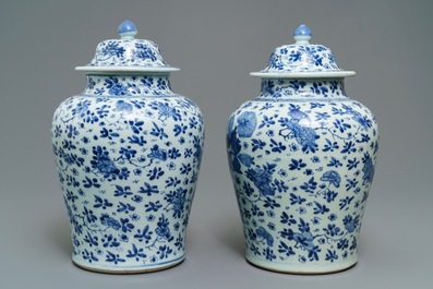 A pair of Chinese blue and white covered vases with floral design, Kangxi