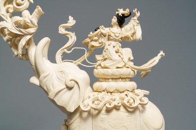 A large Chinese ivory group of an elephant with two ladies, 1st half 20th C.
