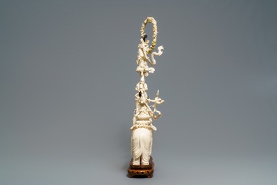 A large Chinese ivory group of an elephant with two ladies, 1st half 20th C.